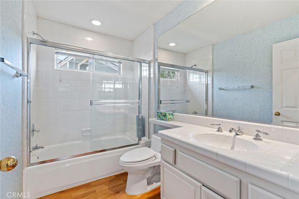 Bathroom, Glass Shower, Interior, Recessed Lighting, Tile Countertops, Wood Texture Flooring