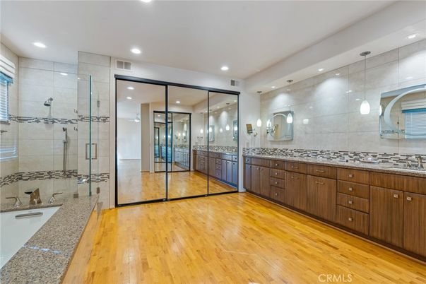 Bathroom, Dual Sink Vanities, Glass Shower, Interior, Recessed Lighting, Wood Texture Flooring