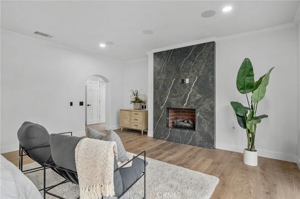 Fireplace, Interior, Marble Walls, Recessed Lighting, Wood Texture Flooring