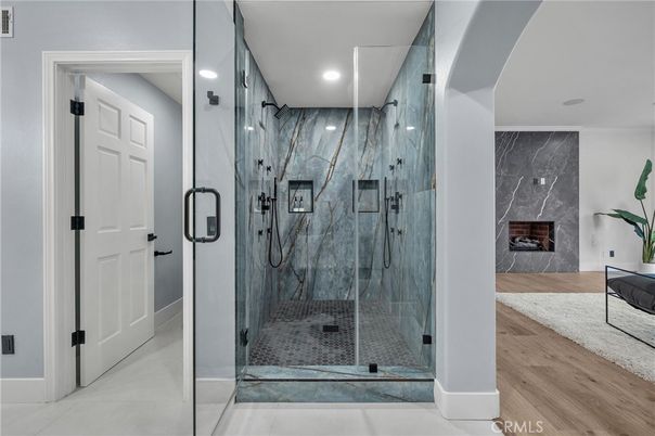 Bathroom, Fireplace, Glass Shower, Interior, Marble Walls, Recessed Lighting, Wood Texture Flooring
