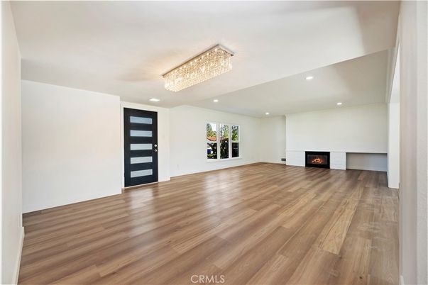Chandelier, Empty room, Fireplace, Interior, Recessed Lighting, Wood Texture Flooring