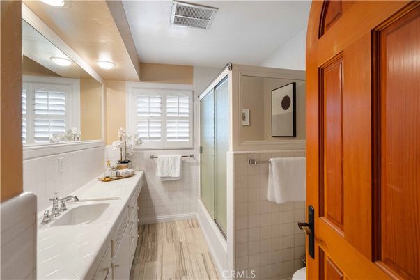 Bathroom, Dual Sink Vanities, Glass Shower, Interior, Tile Countertops, Wood Texture Flooring