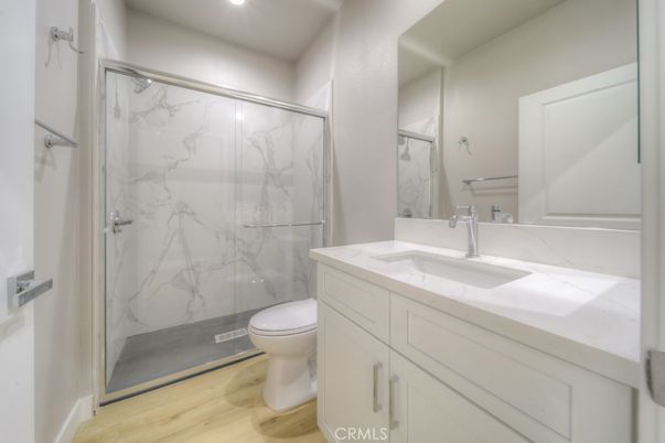 Bathroom, Glass Shower, Interior, Marble Walls, Recessed Lighting, Wood Texture Flooring