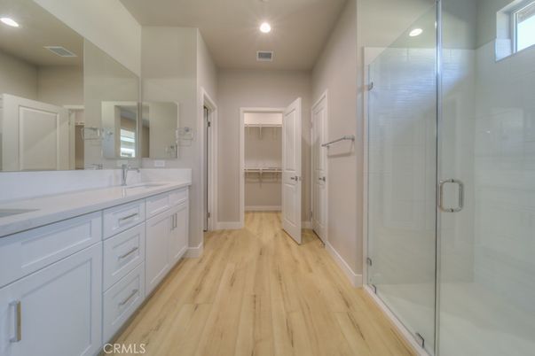 Bathroom, Dual Sink Vanities, Glass Shower, Interior, Recessed Lighting, Walk-in Closets, Wood Texture Flooring