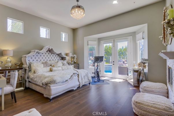 Bedroom, Chandelier, Fireplace, Fitness Equipment, Interior, Recessed Lighting, Wood Texture Flooring