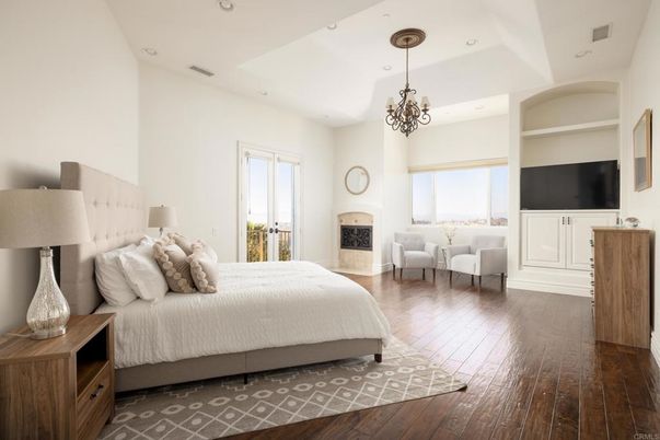 Bedroom, Chandelier, Fireplace, Interior, Recessed Lighting, Wood Texture Flooring