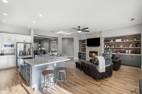 Fireplace, Interior, Kitchen, Living room, Recessed Lighting, Stainless Steel Appliances, Stone Walls, Wood Texture Flooring