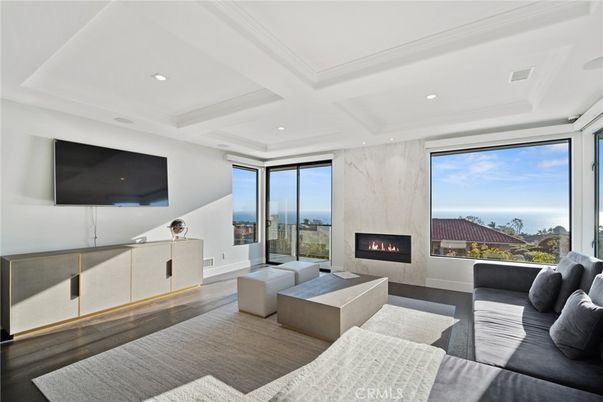 Fireplace, Interior, Living room, Marble Walls, Recessed Lighting, Water, Wood Texture Flooring