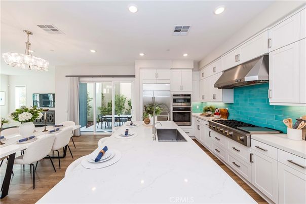 Chandelier, Dining room, Interior, Kitchen, Recessed Lighting, Stainless Steel Appliances, Wood Texture Flooring
