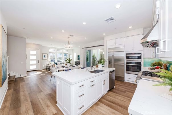 Chandelier, Dining room, Interior, Kitchen, Recessed Lighting, Stainless Steel Appliances, Wood Texture Flooring