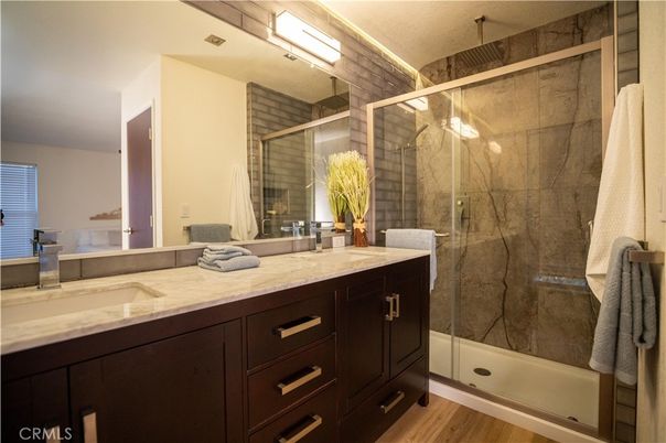 Bathroom, Dual Sink Vanities, Glass Shower, Interior, Marble Walls, Wood Texture Flooring