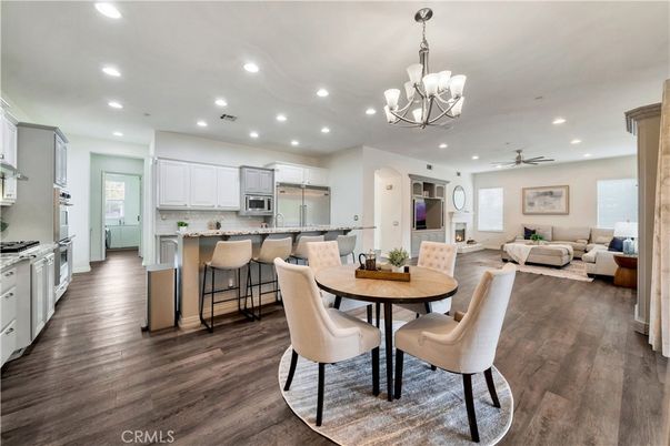 Chandelier, Dining room, Interior, Kitchen, Living room, Recessed Lighting, Stainless Steel Appliances, Wood Texture Flooring