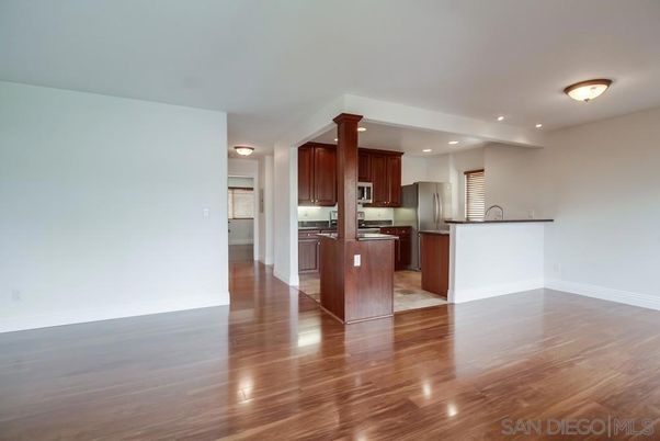 Empty room, Interior, Kitchen, Recessed Lighting, Stainless Steel Appliances, Wood Texture Flooring