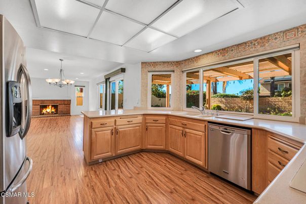 Chandelier, Fireplace, Interior, Kitchen, Recessed Lighting, Stainless Steel Appliances, Wood Texture Flooring