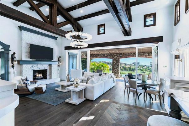 Chandelier, Dining room, Fireplace, Interior, Living room, Pendant Lights, Recessed Lighting, Stone Walls, Wooden Beams, Wood Texture Flooring