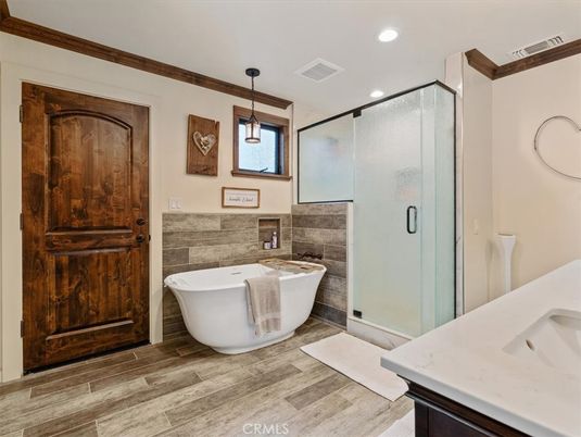 Bathroom, Free Standing Baths, Glass Shower, Interior, Pendant Lights, Recessed Lighting, Wood Texture Flooring