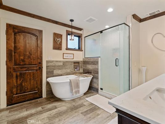 Bathroom, Free Standing Baths, Glass Shower, Interior, Pendant Lights, Recessed Lighting, Wood Texture Flooring