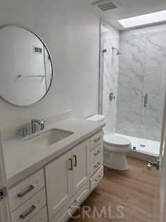 Bathroom, Dual Sink Vanities, Glass Shower, Interior, Marble Walls, Wood Texture Flooring