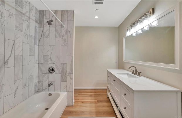 Bathroom, Dual Sink Vanities, Interior, Marble Walls, Recessed Lighting, Wood Texture Flooring