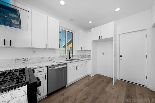 Interior, Kitchen, Marble Walls, Recessed Lighting, Stainless Steel Appliances, Wood Texture Flooring