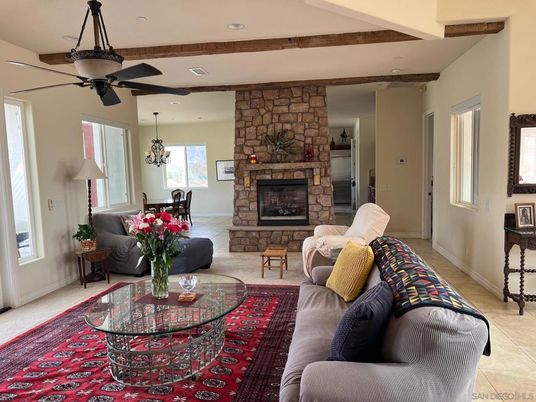 Chandelier, Dining room, Fireplace, Interior, Living room, Recessed Lighting, Stone Walls, Wooden Beams
