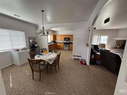 Chandelier, Dining room, Fireplace, Interior, Kitchen, Living room, Pendant Lights, Stainless Steel Appliances