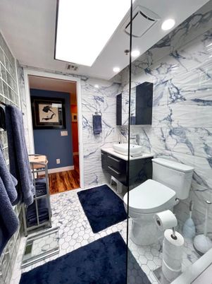 Bathroom, Glass Shower, Interior, Marble, Marble Walls, Recessed Lighting, Wood Texture Flooring