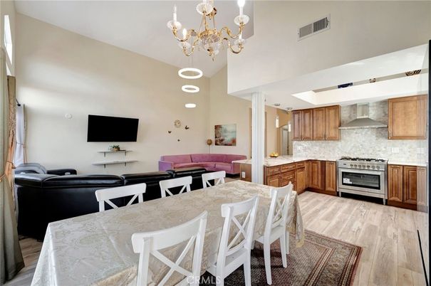 Chandelier, Dining room, Interior, Kitchen, Living room, Recessed Lighting, Stainless Steel Appliances, Wood Texture Flooring