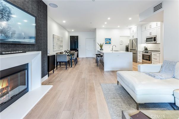 Dining room, Fireplace, Interior, Kitchen, Living room, Recessed Lighting, Stainless Steel Appliances, Wood Texture Flooring