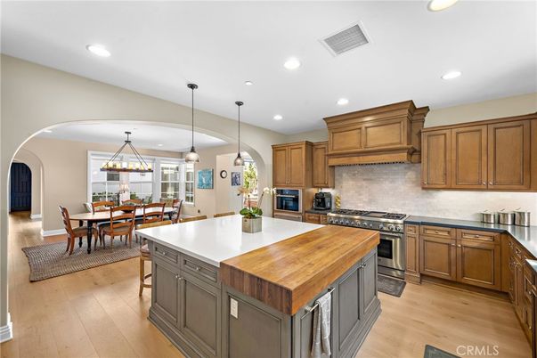 Chandelier, Dining room, Interior, Kitchen, Pendant Lights, Recessed Lighting, Stainless Steel Appliances, Wood Texture Flooring