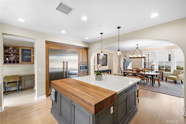Chandelier, Dining room, Interior, Kitchen, Living room, Pendant Lights, Recessed Lighting, Stainless Steel Appliances, Wood Texture Flooring