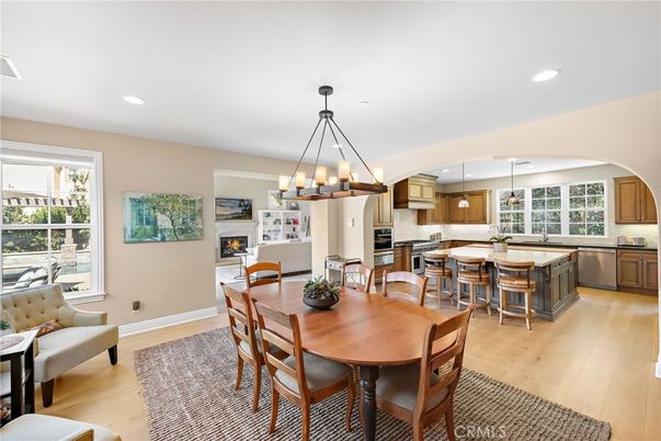 Chandelier, Dining room, Fireplace, Interior, Kitchen, Living room, Pendant Lights, Recessed Lighting, Stainless Steel Appliances, Wood Texture Flooring