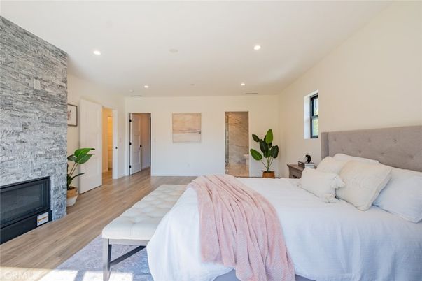 Bedroom, Fireplace, Interior, Recessed Lighting, Stone Walls, Wood Texture Flooring