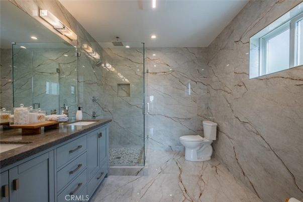Bathroom, Dual Sink Vanities, Glass Shower, Interior, Marble, Marble Walls, Recessed Lighting