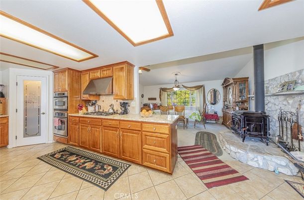 Dining room, Fireplace, Interior, Kitchen, Pendant Lights, Stainless Steel Appliances, Stone Walls