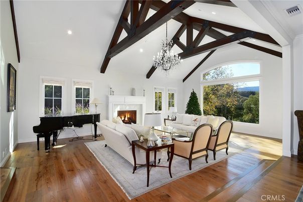 Chandelier, Fireplace, Interior, Living room, Piano, Recessed Lighting, Wooden Beams, Wood Texture Flooring