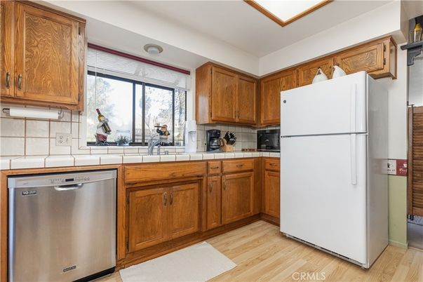 Interior, Kitchen, Stainless Steel Appliances, Tile Countertops, Wood Texture Flooring