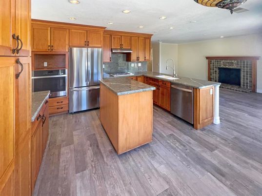 Fireplace, Interior, Kitchen, Recessed Lighting, Stainless Steel Appliances, Wood Texture Flooring