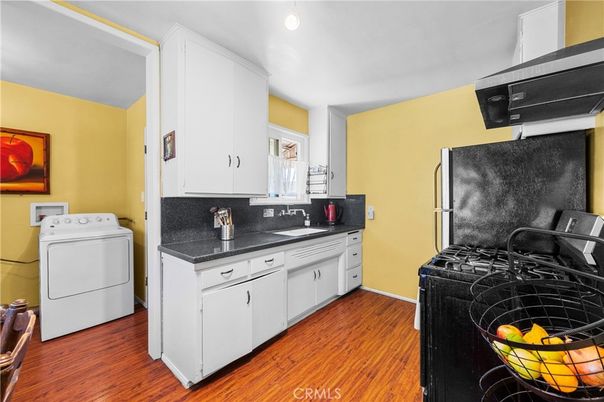 Interior, Kitchen, Recessed Lighting, Washer, Wood Texture Flooring