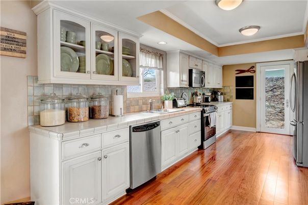 Interior, Kitchen, Recessed Lighting, Stainless Steel Appliances, Tile Countertops, Wood Texture Flooring