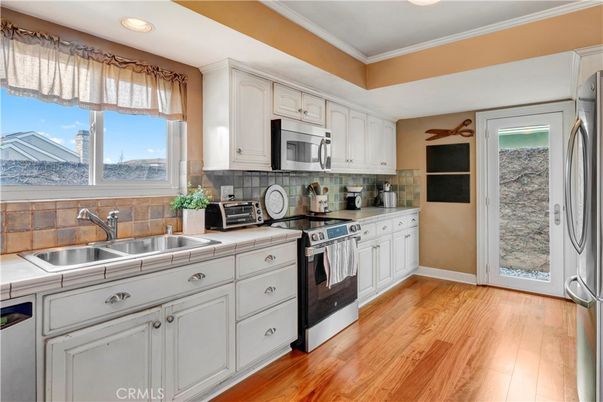 Interior, Kitchen, Recessed Lighting, Tile Countertops, Wood Texture Flooring