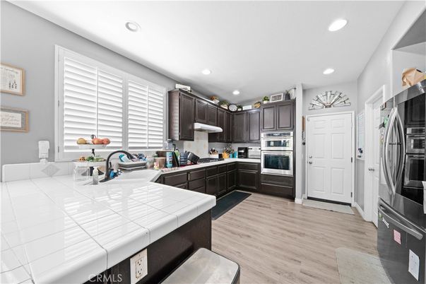 Interior, Kitchen, Recessed Lighting, Stainless Steel Appliances, Tile Countertops, Wood Texture Flooring
