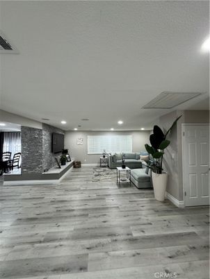 Fitness Equipment, Interior, Living room, Recessed Lighting, Stone Walls, Wood Texture Flooring