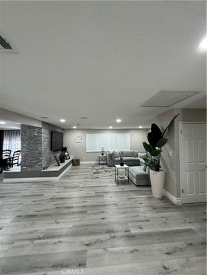 Fitness Equipment, Interior, Living room, Recessed Lighting, Stone Walls, Wood Texture Flooring