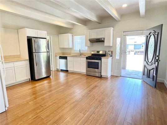 Interior, Kitchen, Recessed Lighting, Stainless Steel Appliances, Washer, Wood Texture Flooring