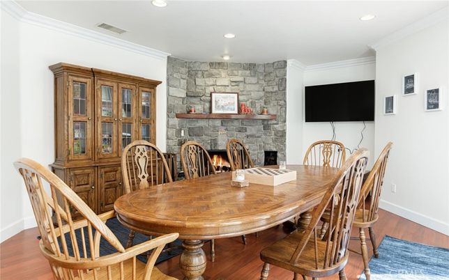 Dining room, Fireplace, Interior, Recessed Lighting, Stone Walls, Wood Texture Flooring