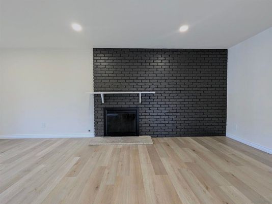 Empty room, Fireplace, Interior, Recessed Lighting, Stone Walls, Wood Texture Flooring