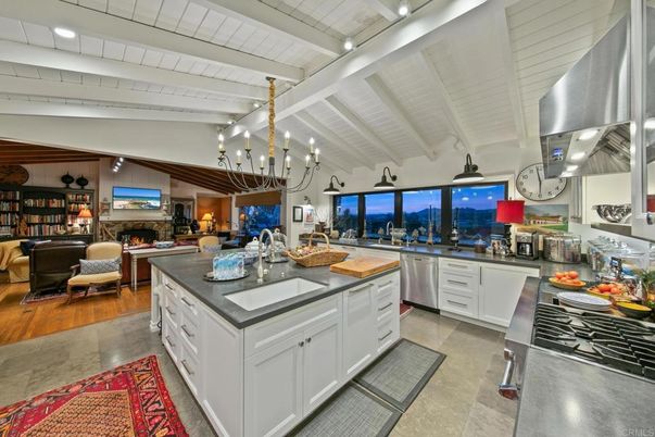 Chandelier, Fireplace, Interior, Kitchen, Living room, Pendant Lights, Recessed Lighting, Stainless Steel Appliances, Wood Texture Flooring