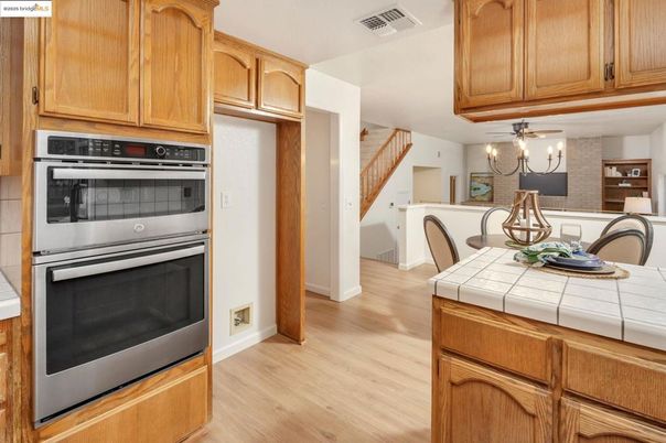 Chandelier, Dining room, Interior, Kitchen, Stainless Steel Appliances, Tile Countertops, Wood Texture Flooring
