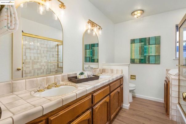Bathroom, Dual Sink Vanities, Glass Shower, Interior, Tile Countertops, Wood Texture Flooring